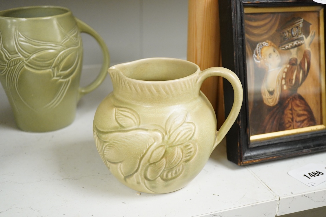 Three Susie Cooper green floral incised jugs, signed to the bases, tallest 16cm high